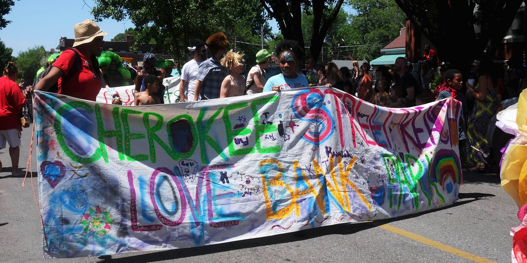 Cherokee Street Reach and their Love Bank Park banner. Photo by Paul Sableman.