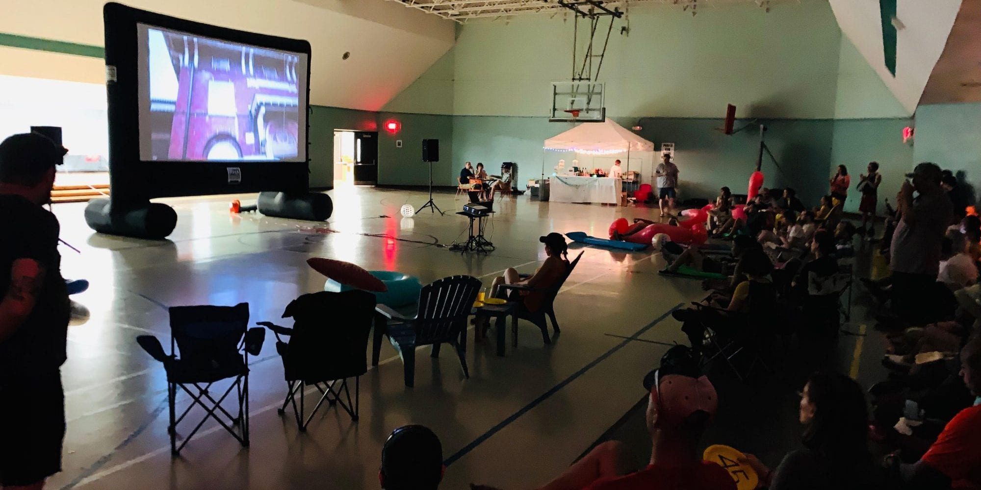 Neighbors gather in the Marquette Rec Center for a movie night fundraiser.