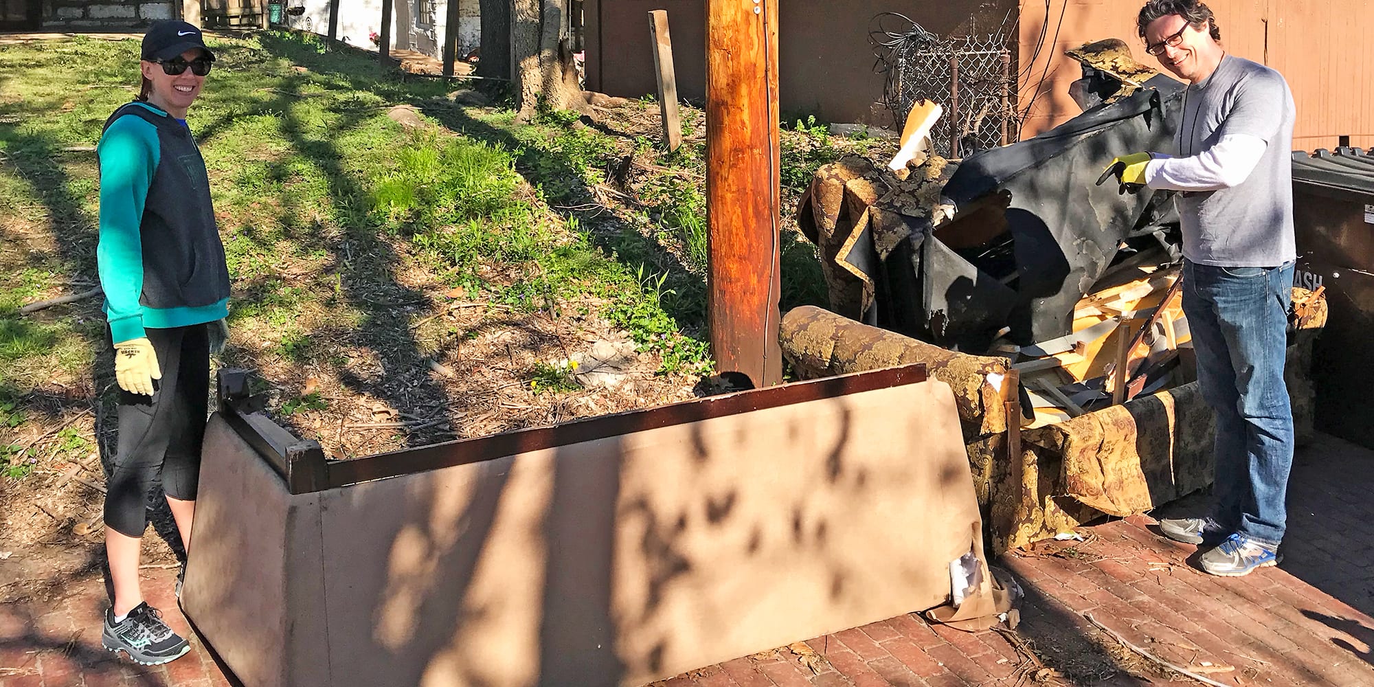 Dutchtown CID Board Chair Ashley Raineri and 25th Ward NIS Christian Saller remove furniture from an alley in Dutchtown.