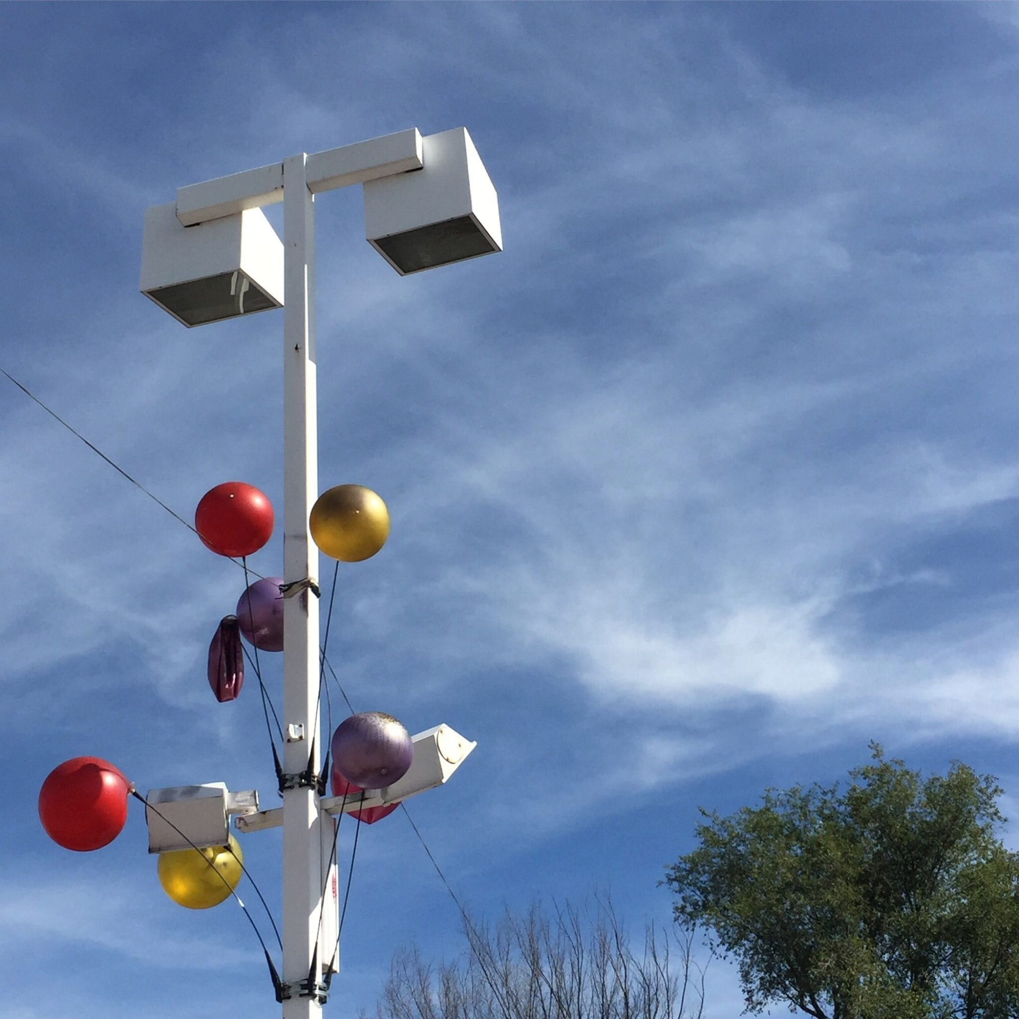 Balloons on a light pole in Dutchtown, St. Louis. Photo by Josh Burbridge.