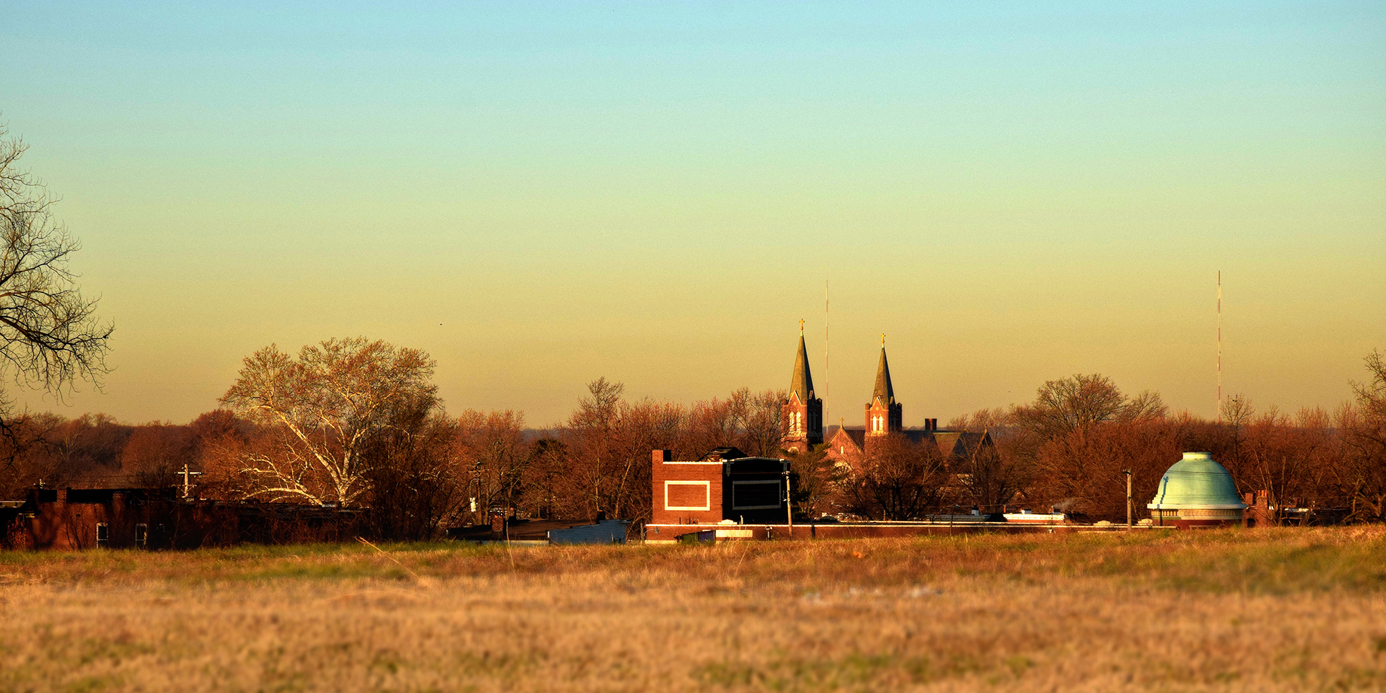 The steeples of St. Cecilia and the dome of the Virginia Theater as seen from Minnesota and Hill Park in Dutchtown, St. Louis, MO.