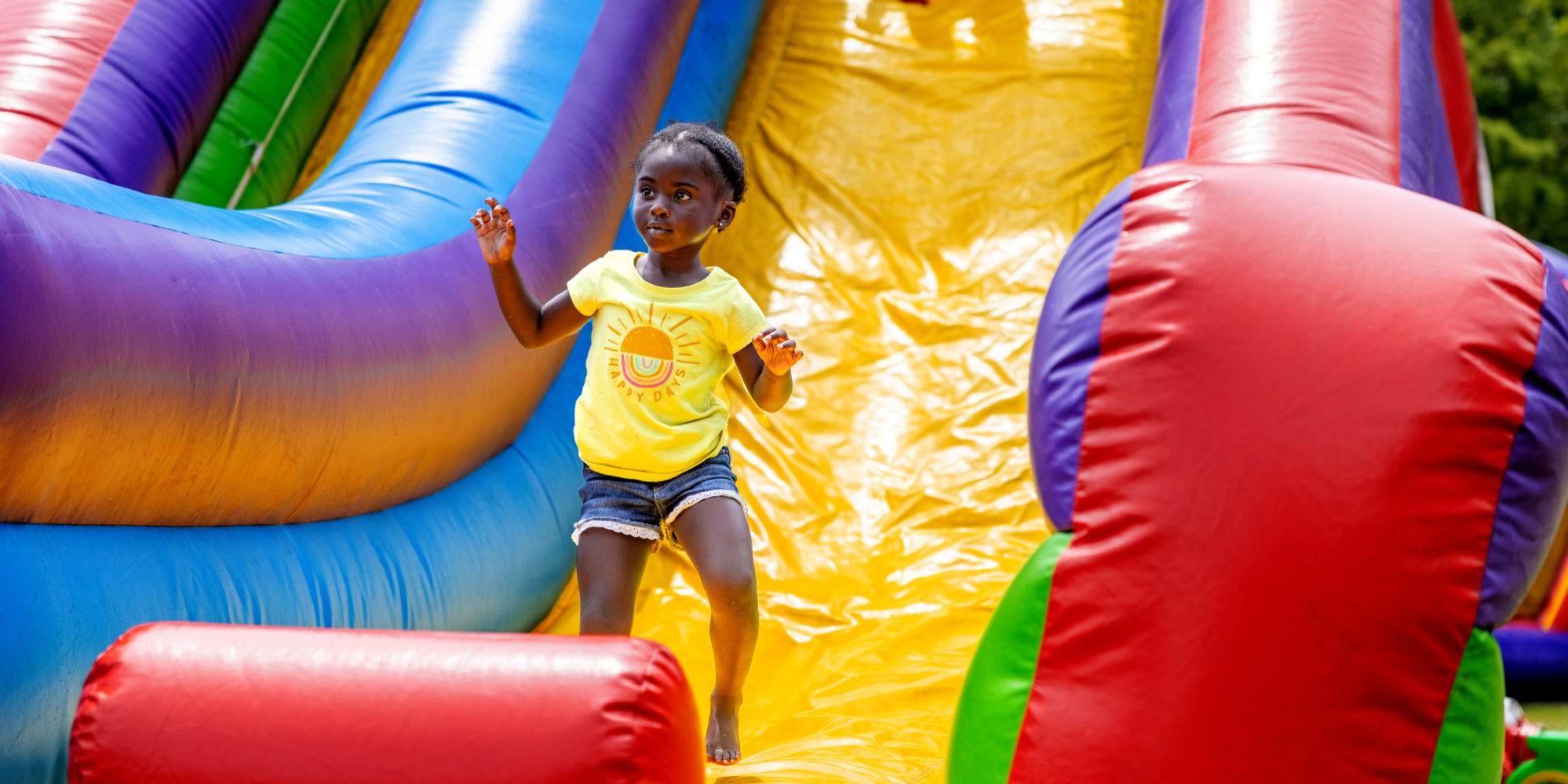 A young girl on an inflatable slide at Marquette Community Day in Dutchtown, St. Louis, MO.