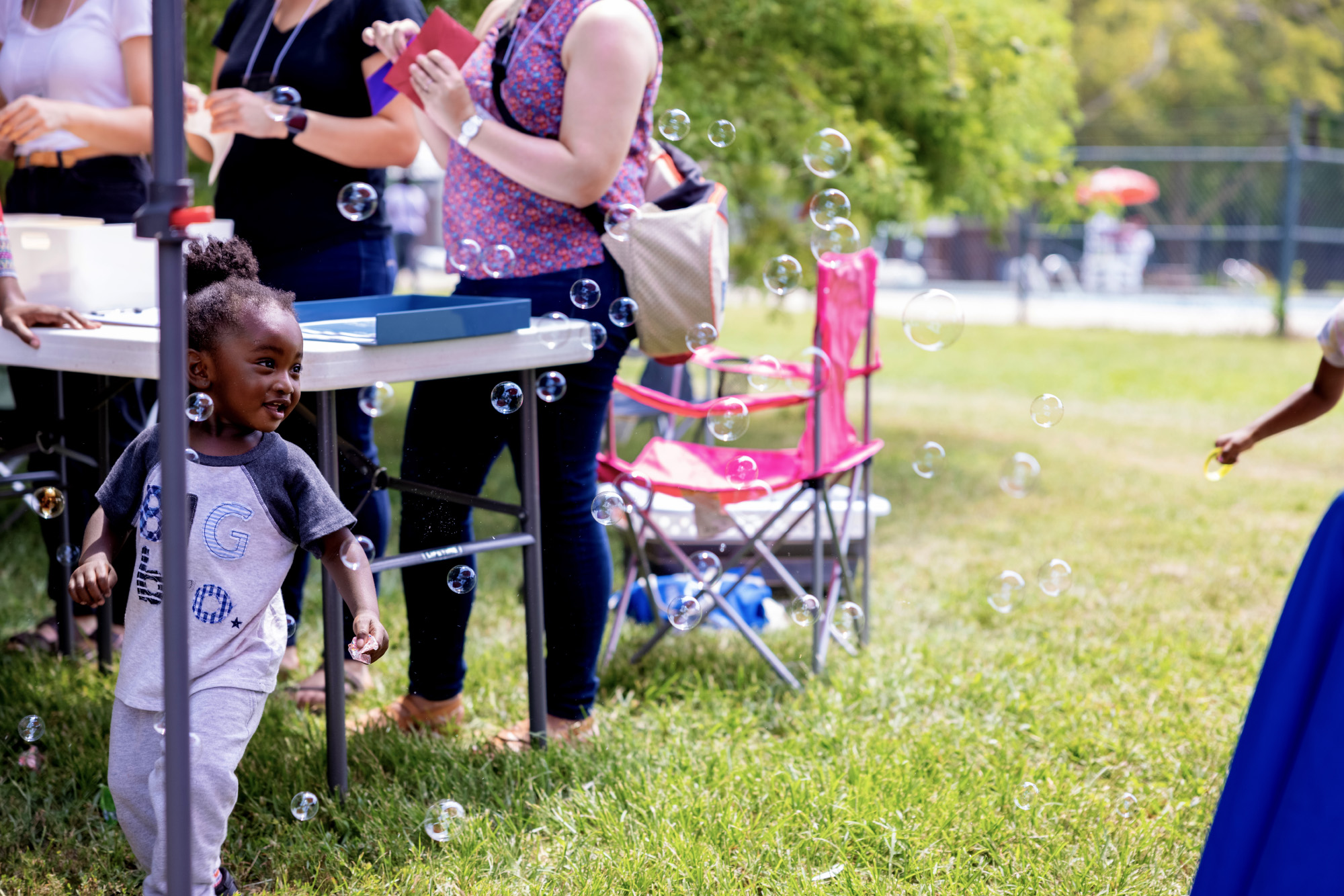 A child playing with bubbles at Marquette Community Day in Dutchtown, St. Louis, MO.