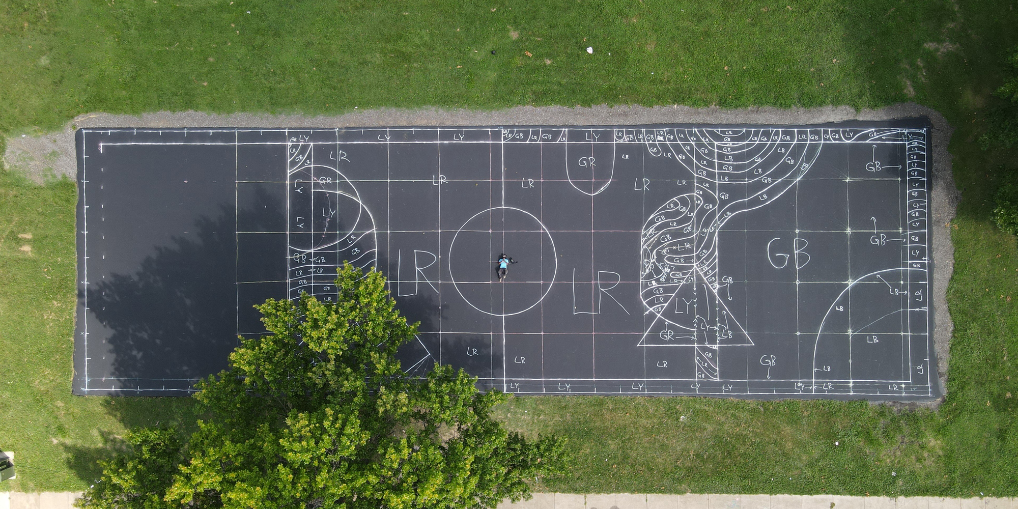 Beginning stages of painting the mural on the futsal court at Marquette Park.