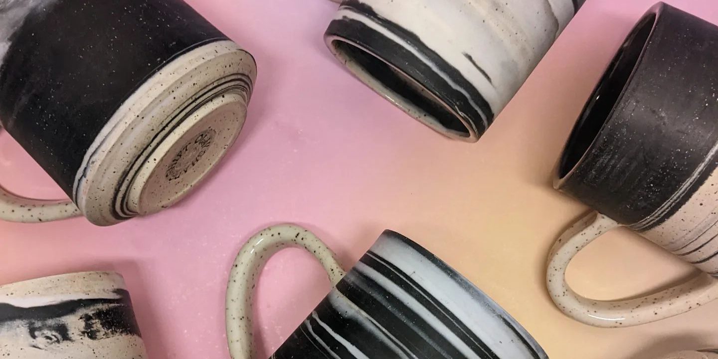 Black and white ceramic mugs by artist Julie Batisto of Shape Shift Clay.