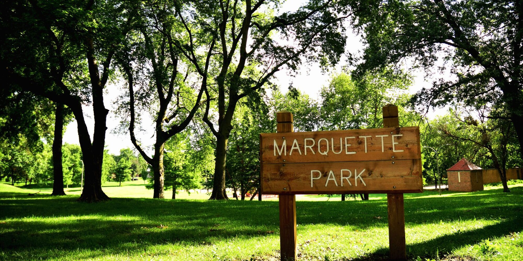 A wooden sign at the corner of Marquette Park in Dutchtown, St. Louis, MO.