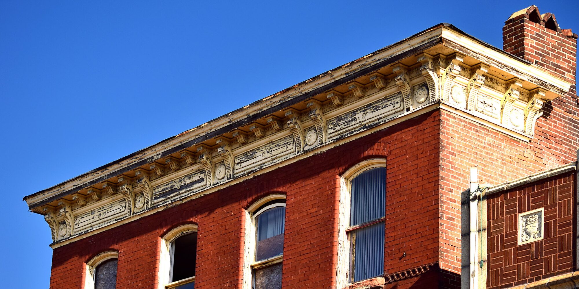 Closeup of the cornice at the top of 3305 Meramec Street, a building in Downtown Dutchtown that is soon to be rehabbed by Lutheran Development Group as part of their Marquette Homes project to bring high-quality affordable housing to the neighborhood.